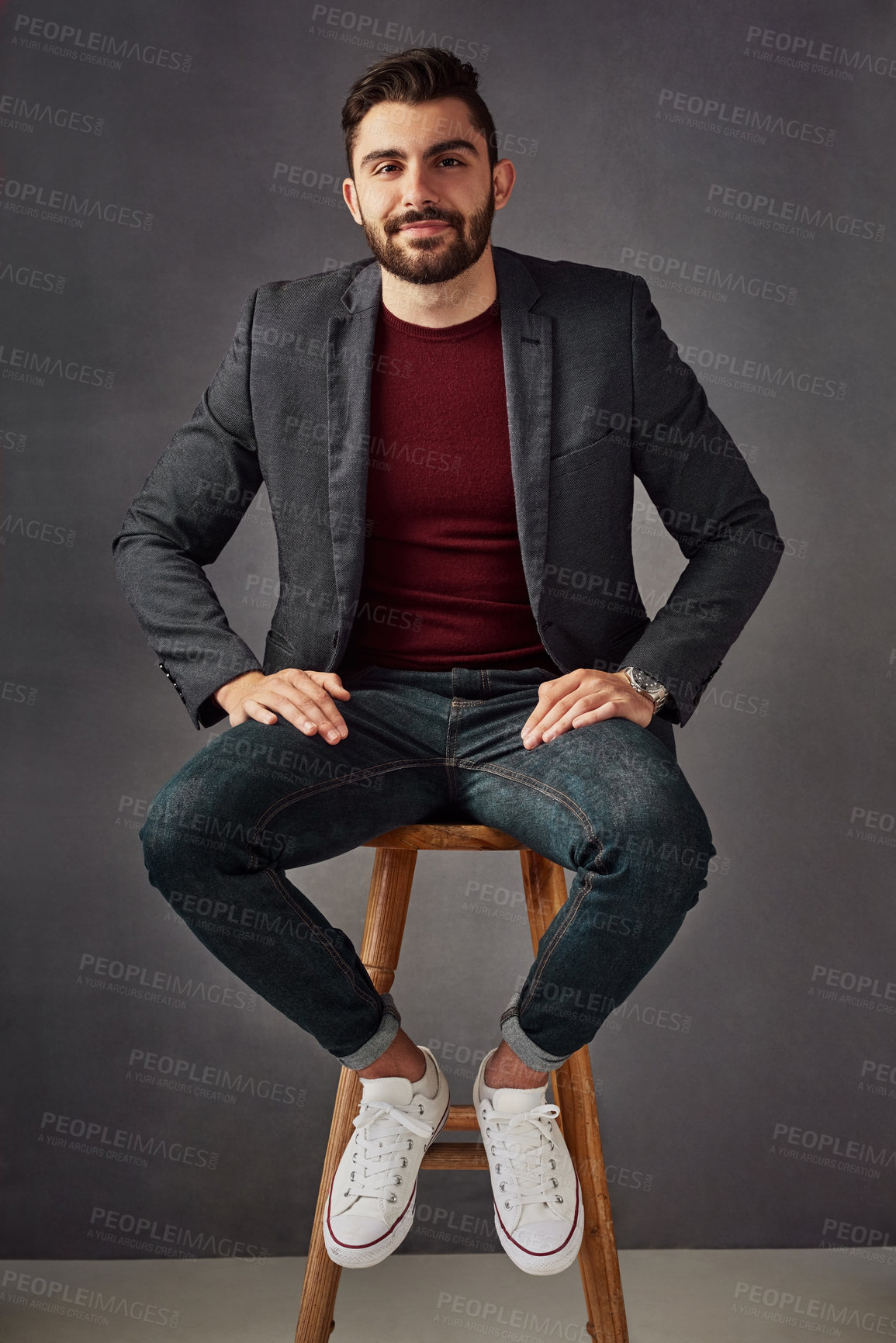 Buy stock photo Portrait, man and smile on stool in studio with casual clothes, trendy fashion and suit jacket as real estate agent. Business, person and chair for investment, property advice and gray background