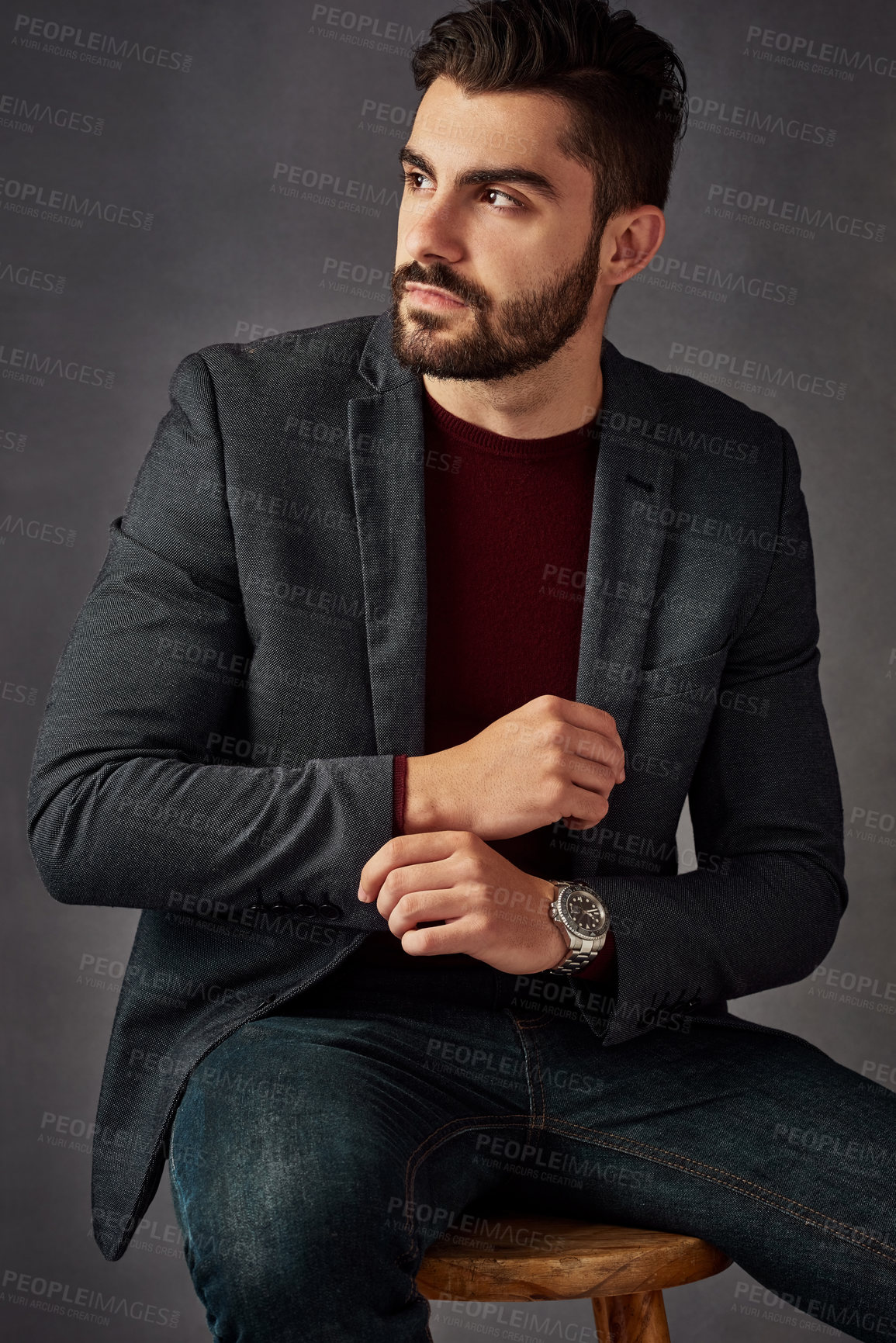 Buy stock photo Studio shot of a handsome young man posing against a dark background