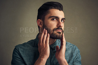 Buy stock photo Man, grooming and touch beard on studio background for facial hair maintenance, self care and texture. Male person, growth and personal hygiene on face for skin, beauty and morning routine as barber