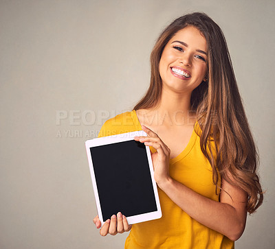 Buy stock photo Happy woman, portrait and tablet with screen for app, advertising or marketing on a studio background. Female person, brunette or model with smile for technology display, presentation or mockup space