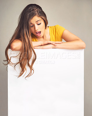 Buy stock photo Woman, surprise and blank placard in studio advertising, marketing or announcement with mockup space. Female person, shocked and empty banner for branding, news and promotion with background or logo 