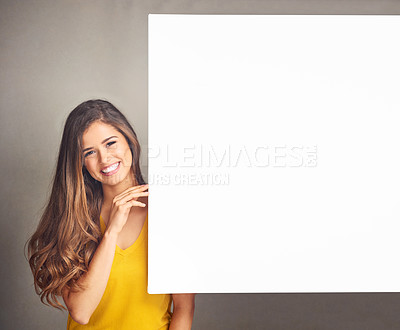 Buy stock photo Woman, smile and portrait with billboard in studio for design, poster and advertising information. Happy, person and mockup space on paper banner for marketing, sign and promotion on gray background