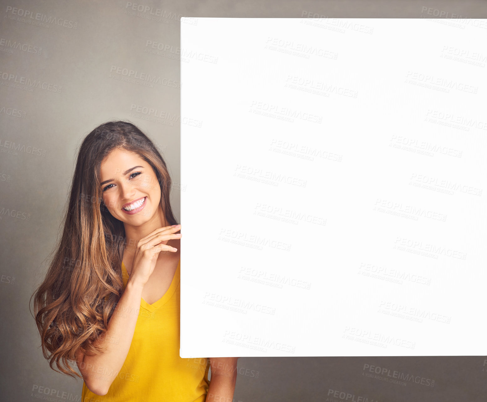 Buy stock photo Woman, smile and portrait with billboard in studio for design, poster and advertising information. Happy, person and mockup space on paper banner for marketing, sign and promotion on gray background