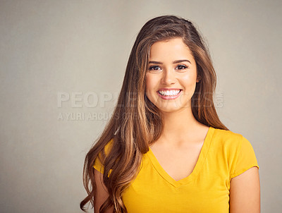 Buy stock photo Studio shot of a beautiful young woman posing against a grey background