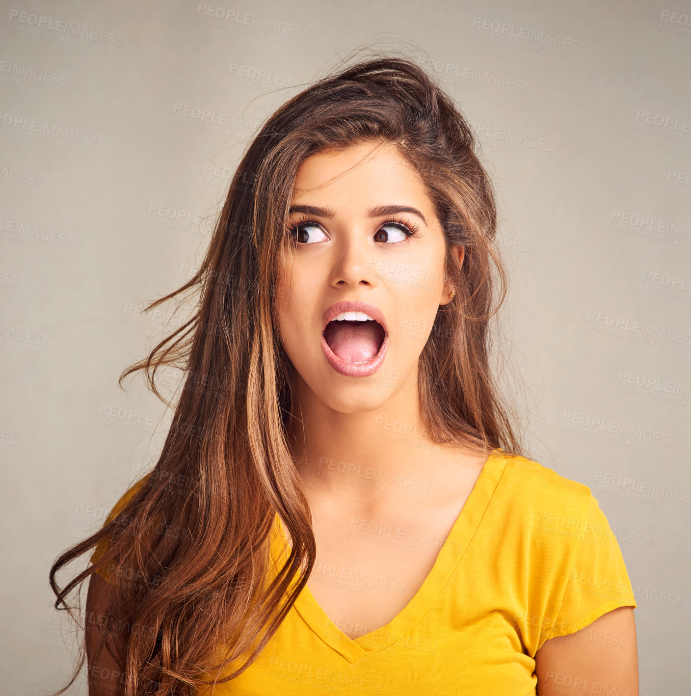 Buy stock photo Closeup of an expressive young woman against a grey background