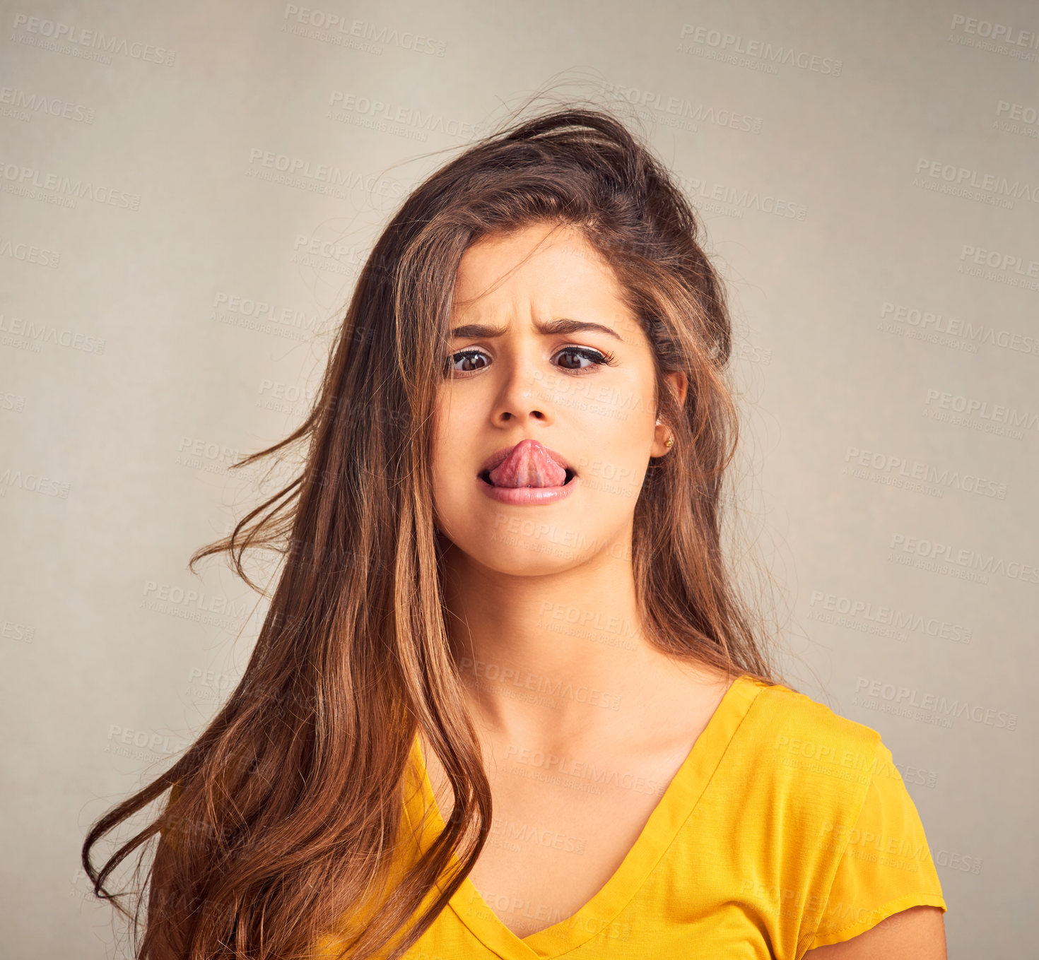 Buy stock photo Tongue out, silly and woman in studio with emoji reaction, facial expression and crossed eyes. Comic, confident and isolated person with crazy, goofy and funny face for humor on gray background