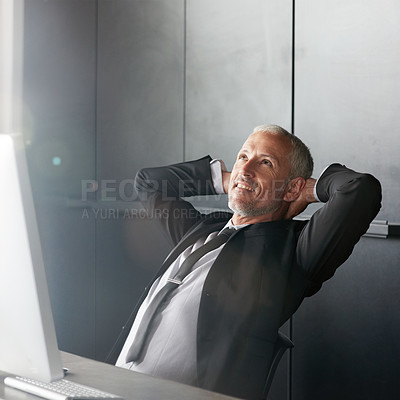Buy stock photo Cropped shot of a handsome mature businessman sitting in the office with his arms behind his neck