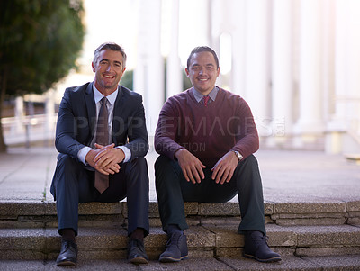 Buy stock photo Portrait of two businessmen having a discussion while seated outside on steps