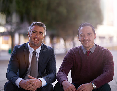Buy stock photo Portrait of two businessmen having a discussion while seated outside on steps