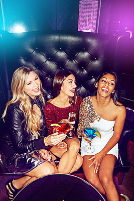 Buy stock photo Women, happy and friends in nightclub with cocktails, drink or glass for vip, event or reunion. Smile, relax and people in dark disco party couch for fashion, alcohol or social celebration in group