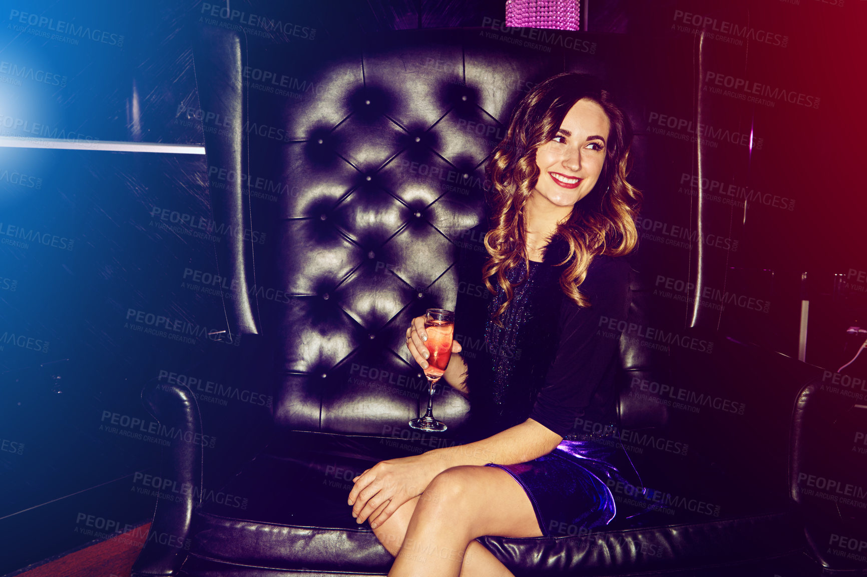 Buy stock photo Shot of a beautiful young woman enjoying a beverage in a nightclub