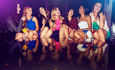 Buy stock photo Girls, vip and friends in nightclub with drink, glass or cocktails as group, event or reunion. Happy, women and people on dark disco party couch for fashion, alcohol or social celebration to relax