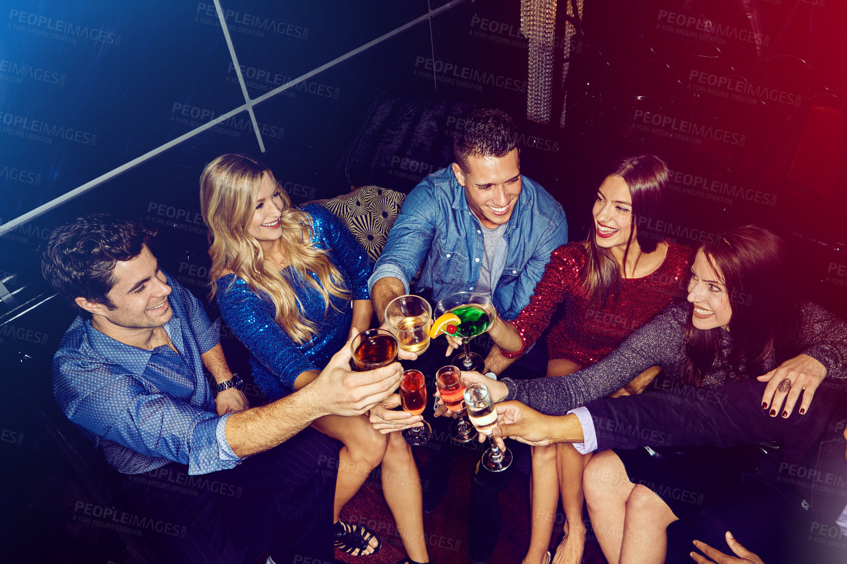 Buy stock photo Shot of a group of friends toasting with drinks at a party