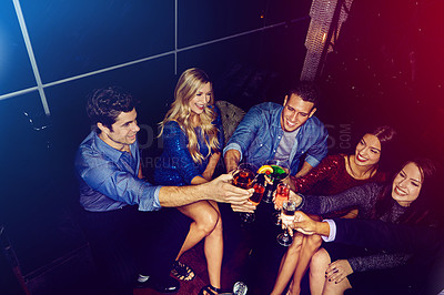 Buy stock photo Shot of a group of friends toasting with drinks at a party