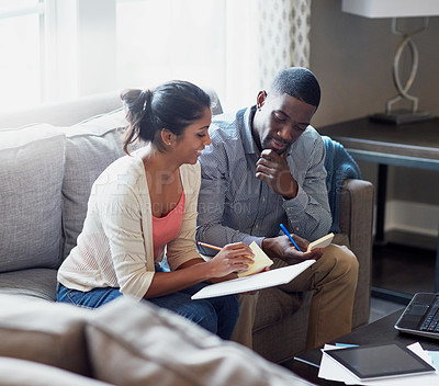 Buy stock photo Couple, notebook and writing on sofa in morning with notes, payments and rent with tax in living room. Technology, tablet and sunlight with people on couch, cover and debt with finance for mortgage.