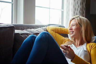 Buy stock photo Happy, thinking and woman on couch, phone and rest in living room, morning and social media in house. Relax, calm and girl with mobile, smile and peace in lounge, cozy and person in apartment