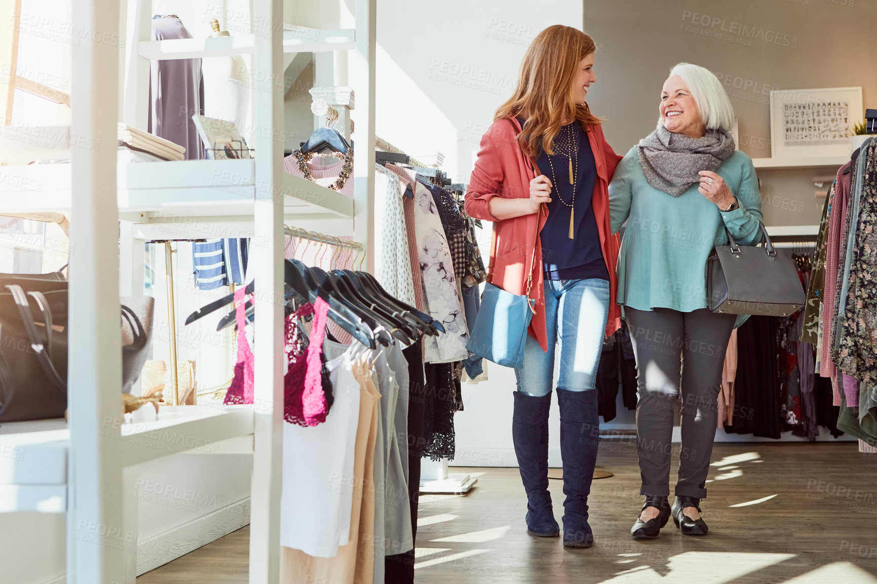 Buy stock photo Shot of a mother and daughter shopping in a clothing store