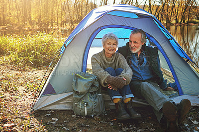 Buy stock photo Shot of a senior couple camping together in the wilderness