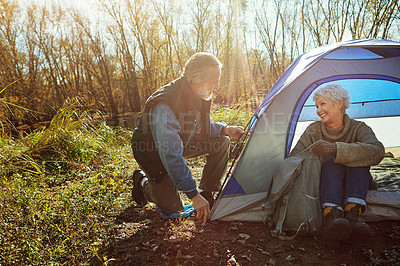 Buy stock photo Shot of a senior couple camping together in the wilderness