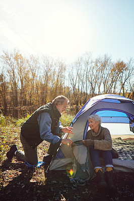 Buy stock photo Shot of a senior couple camping together in the wilderness