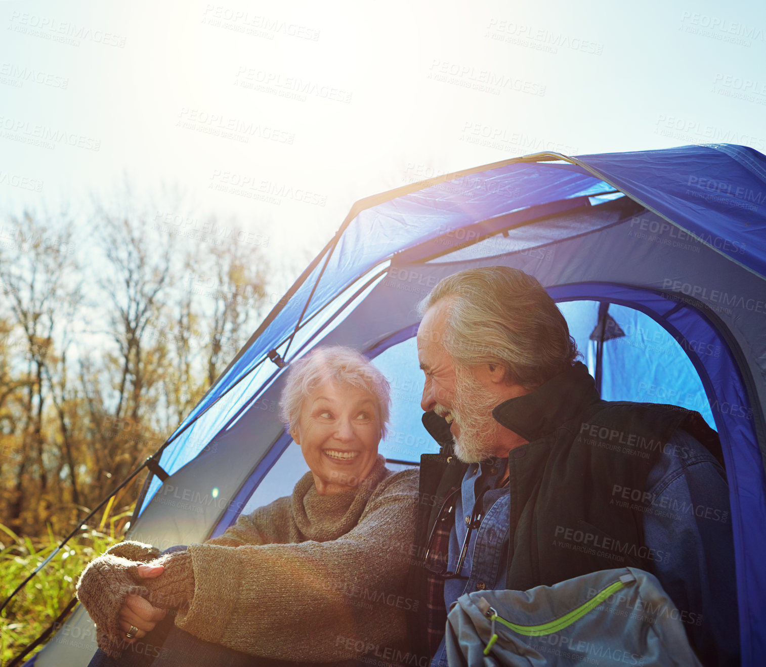 Buy stock photo Shot of a senior couple camping together in the wilderness