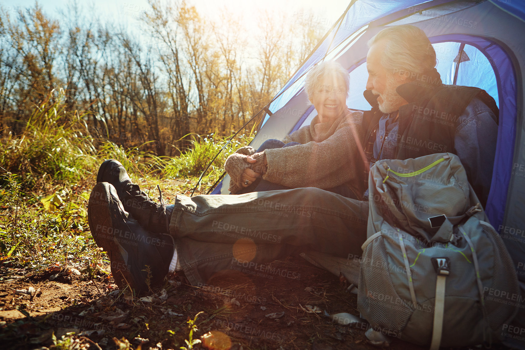 Buy stock photo Shot of a senior couple camping together in the wilderness