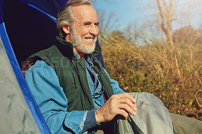 Buy stock photo Shot of a senior man camping in the wilderness