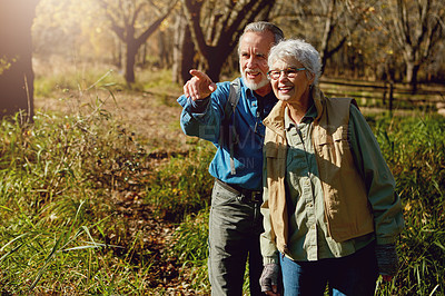 Buy stock photo Shot of a happy senior couple exploring nature together