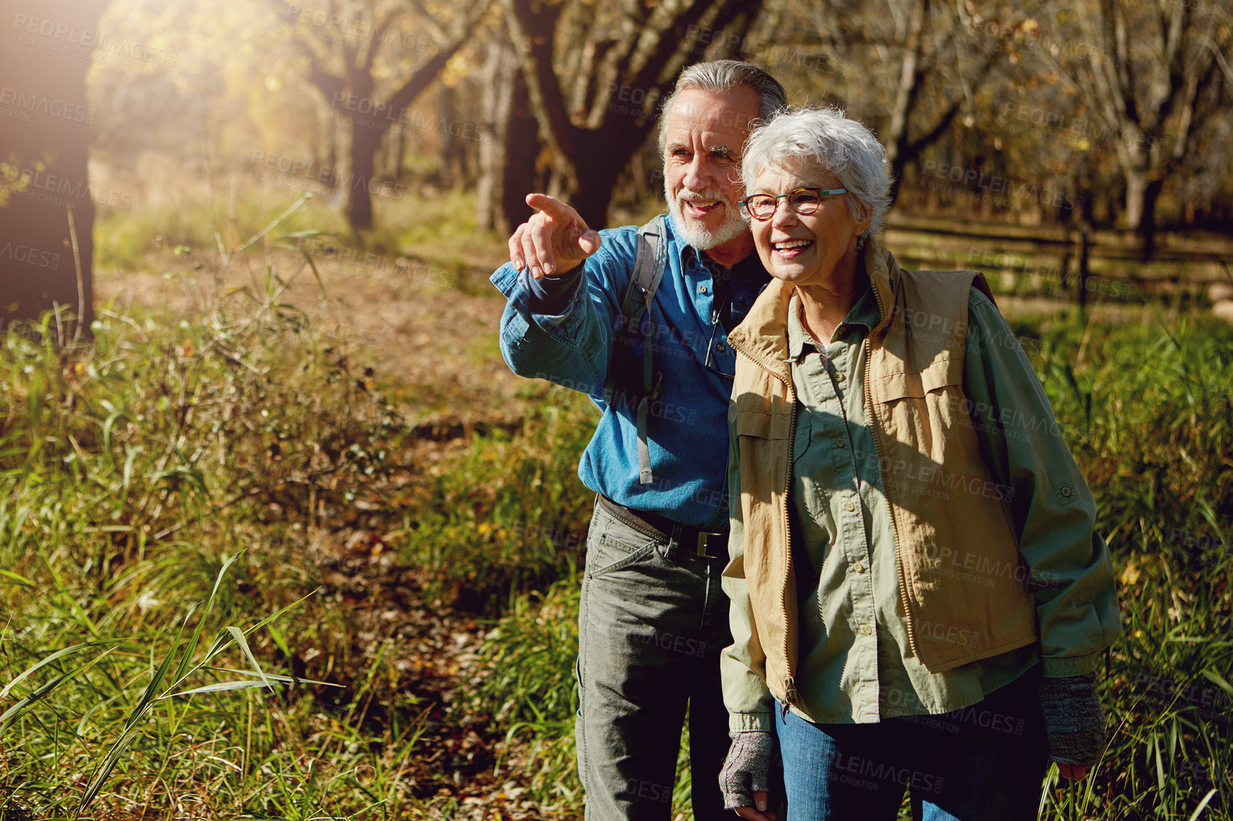 Buy stock photo Shot of a happy senior couple exploring nature together