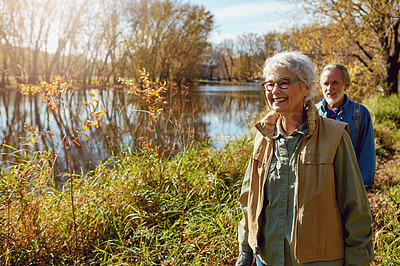 Buy stock photo Shot of a happy senior couple exploring nature together