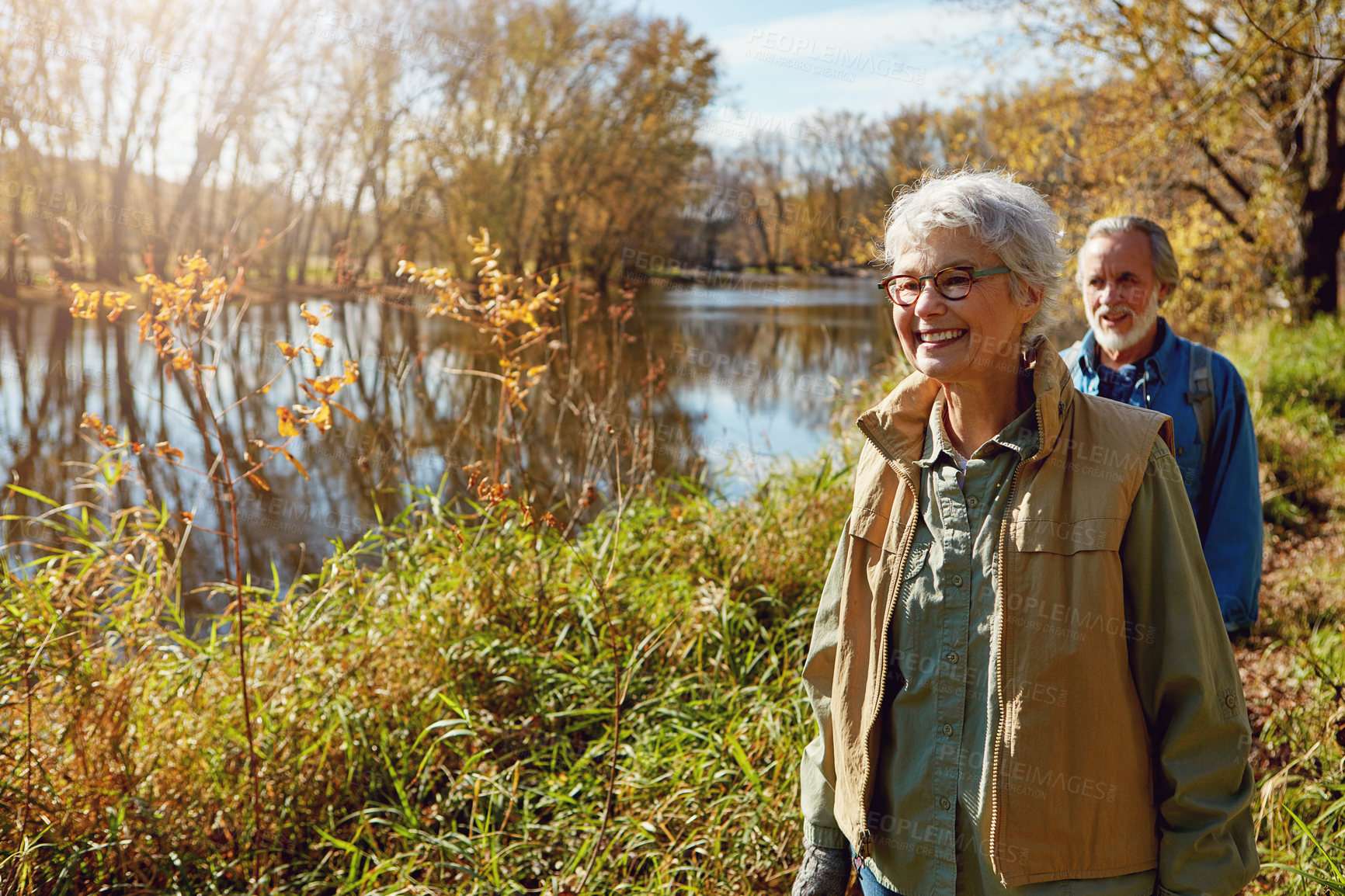 Buy stock photo Shot of a happy senior couple exploring nature together