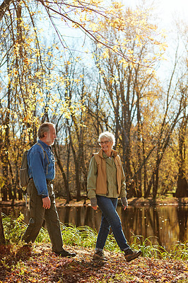 Buy stock photo Shot of a happy senior couple exploring nature together