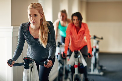 Buy stock photo People, exercise bike and gym for aerobics, training and cycling for fitness at class. Women, riding and stationary machine for workout challenge, spinning instructor and equipment for practice