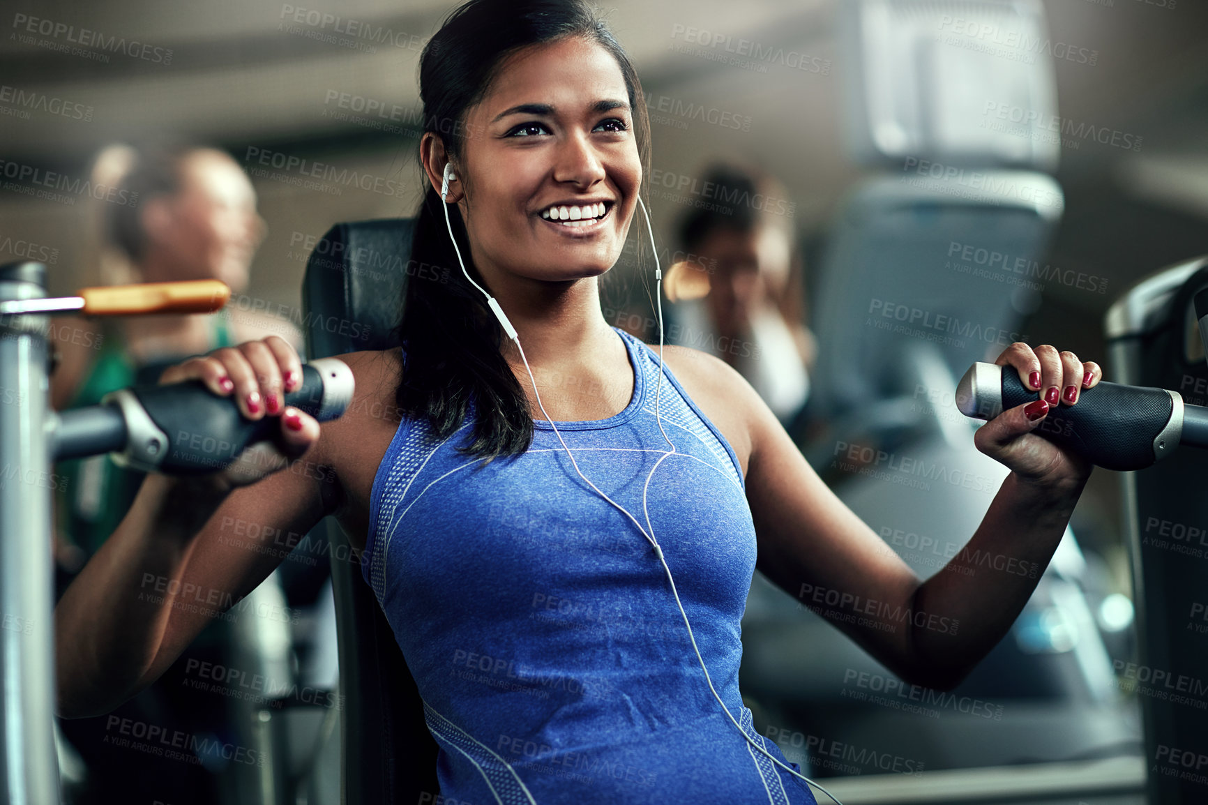 Buy stock photo Shot of a young woman working out with a chest press at a gym