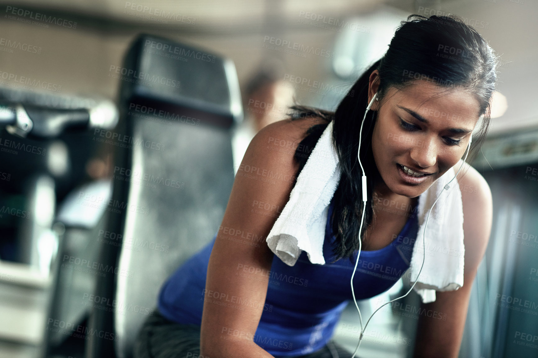 Buy stock photo Shot of a young woman taking a break from her workout at the gym