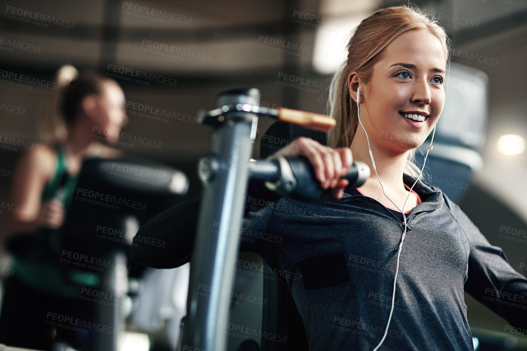 Buy stock photo Gym, woman and happy on chest press machine for workout to exercise for health, fitness and muscles. Female person, smile and earphones with training for wellbeing, wellness and self care in routine