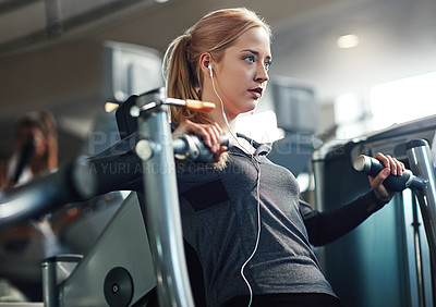 Buy stock photo Gym, woman and concentrate on chest press machine for workout to exercise on health, fitness and muscles. Female person, earphones and music or audio for training, wellness and wellbeing or self care