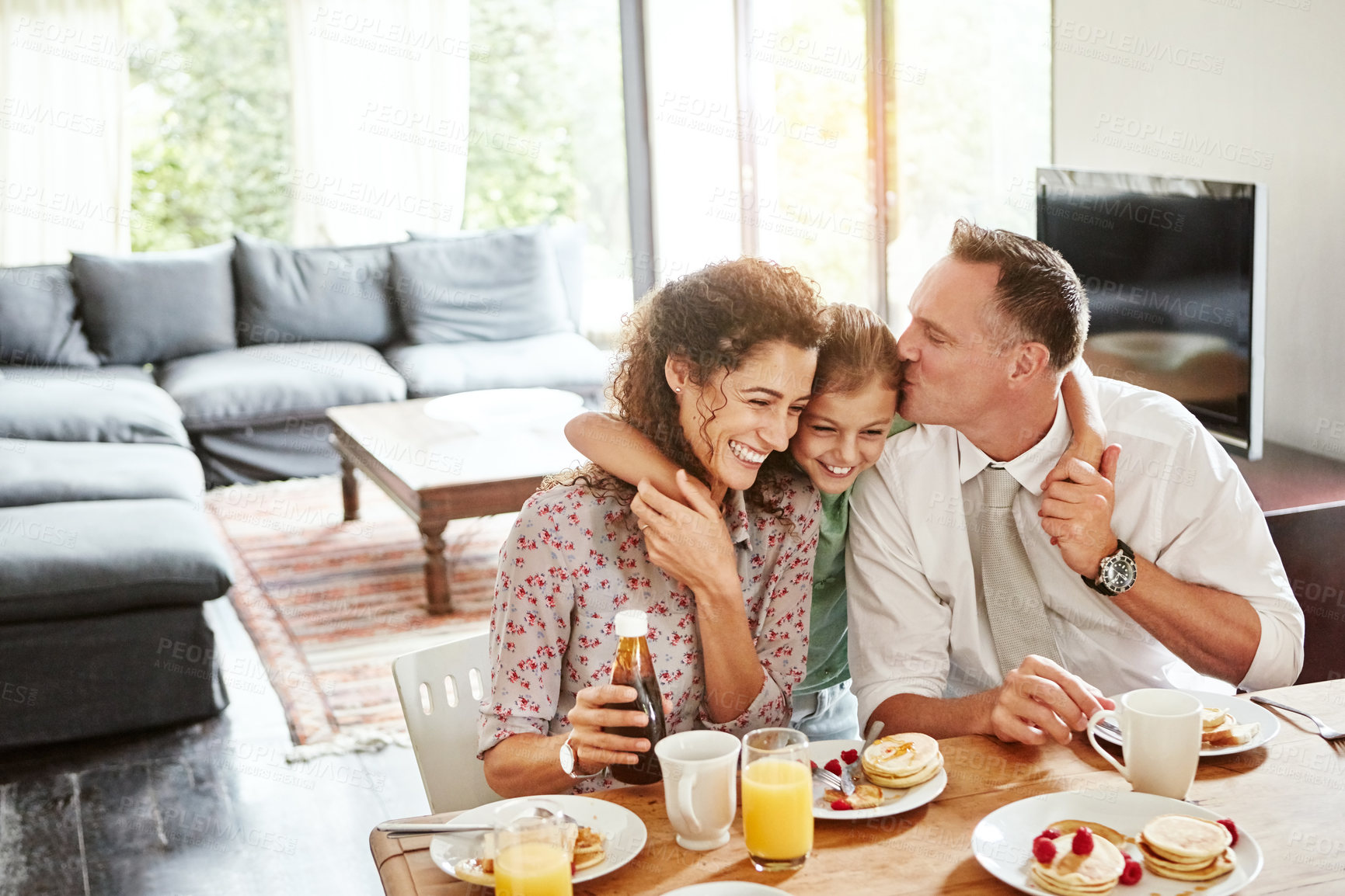 Buy stock photo Shot of a family having breakfast together at home