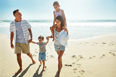 Buy stock photo Parents, children and beach for summer travel vacation, ocean sunshine or sibling together. Man, woman and kid piggy back on sand for family holiday or outdoor clean air, sea relax or love nature