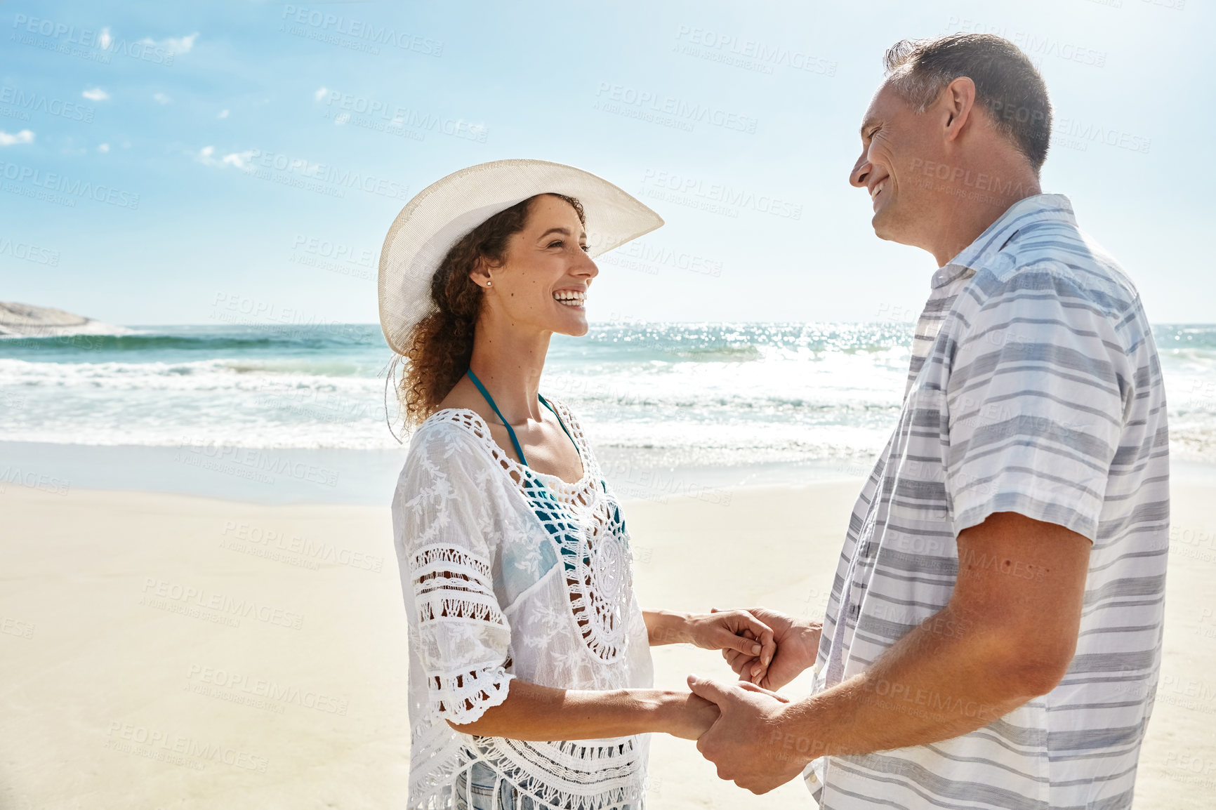Buy stock photo Love, holding hands and support with couple at beach for bonding, smile and summer vacation. Anniversary holiday trip, travel adventure and marriage with man and woman outdoor for connection
