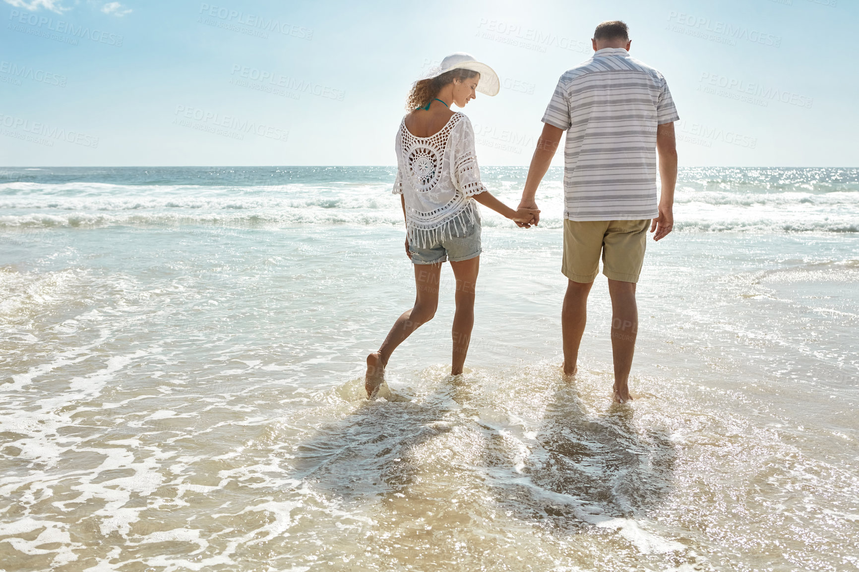 Buy stock photo Shot of a mature couple walking along the beach