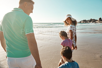 Buy stock photo Shot of a family enjoying some quality time together at the beach