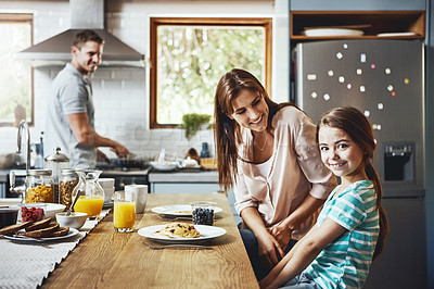 Buy stock photo Portrait, breakfast pancakes and happy girl with family, mother and father, bonding and prepare ingredients. Morning food, cooking and hungry woman, man and daughter in home kitchen eating meal