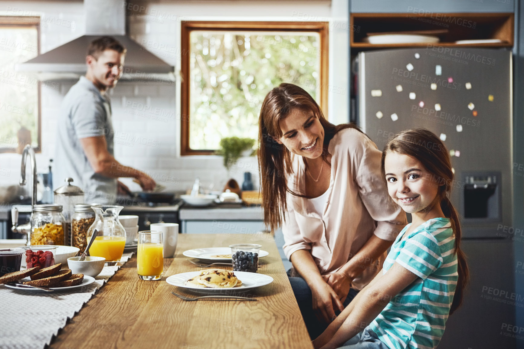 Buy stock photo Portrait, breakfast pancakes and happy girl with family, mother and father, bonding and prepare ingredients. Morning food, cooking and hungry woman, man and daughter in home kitchen eating meal