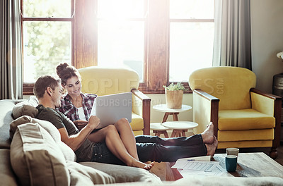 Buy stock photo Couple, laptop and relax in lounge, bills and document of loan, marriage and home in weekend and morning. House, man and woman on sofa, paperwork and together in living room, couch and happiness