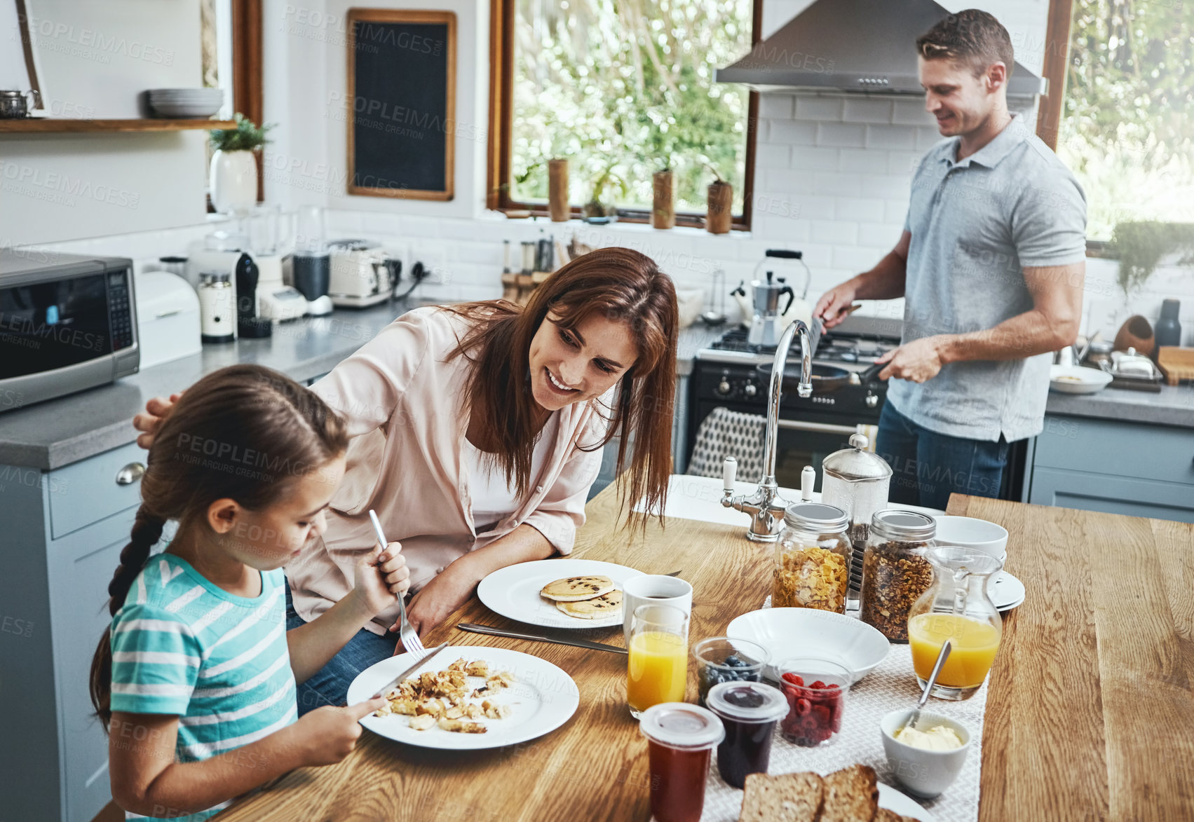 Buy stock photo Love, breakfast pancakes and family bonding with children, mother and father, happy and prepare ingredients. Morning food, cooking and hungry woman, man and daughter in home kitchen eating meal