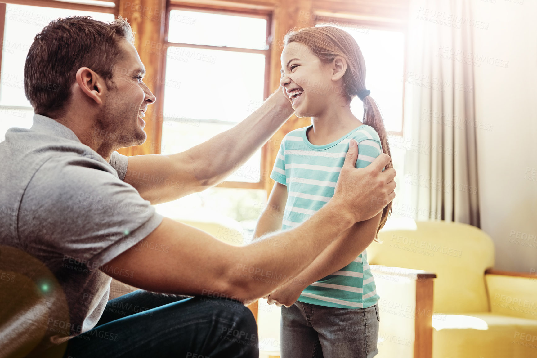 Buy stock photo Shot of a father and his little daughter bonding together at home