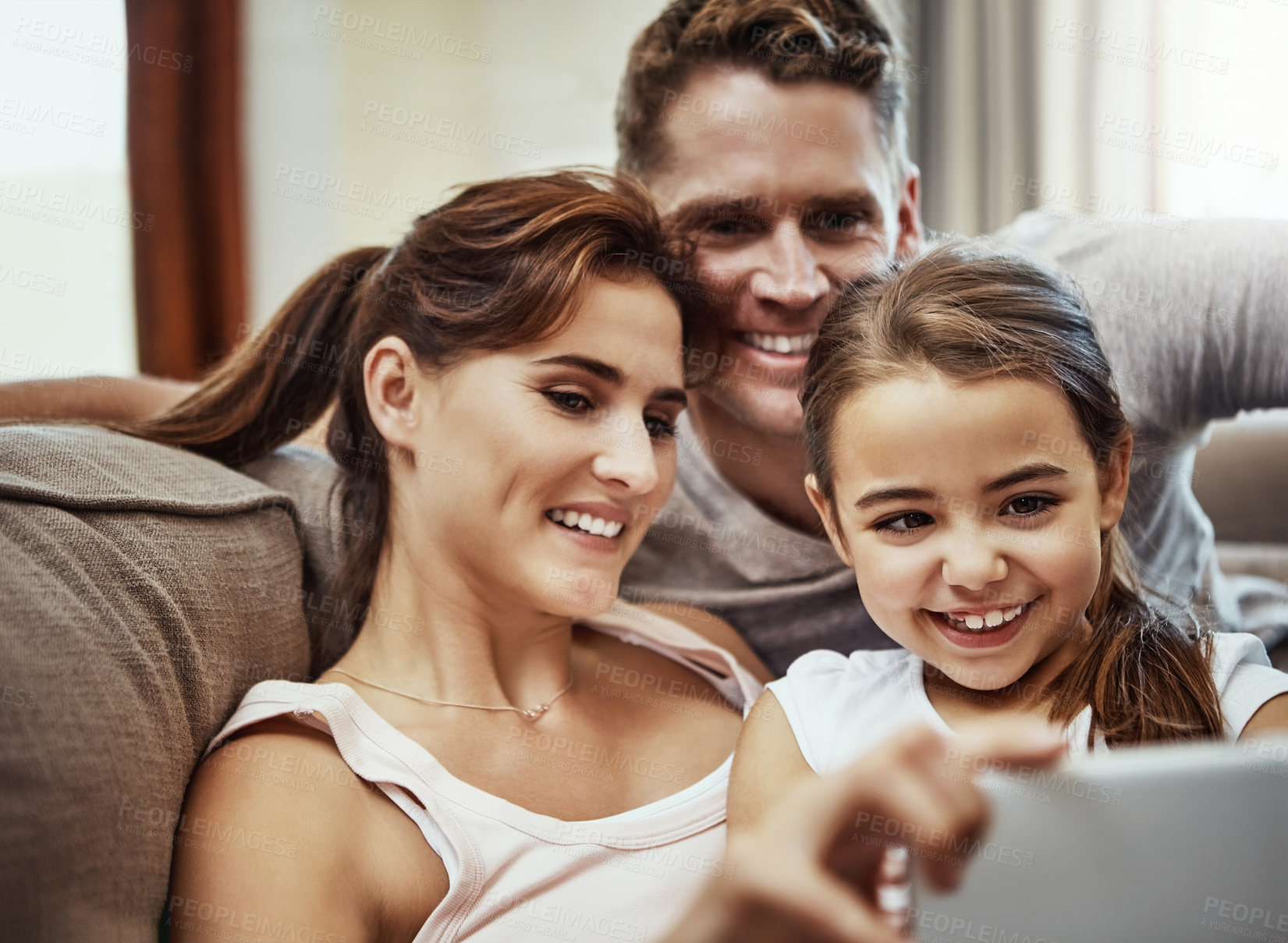 Buy stock photo Shot of a little girl taking a selfie with her parents at home