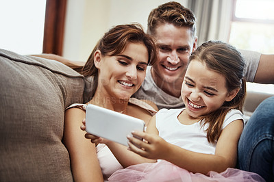 Buy stock photo Shot of a little girl taking a selfie with her parents at home