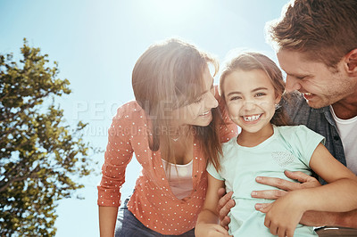 Buy stock photo Shot of a family bonding together outdoors